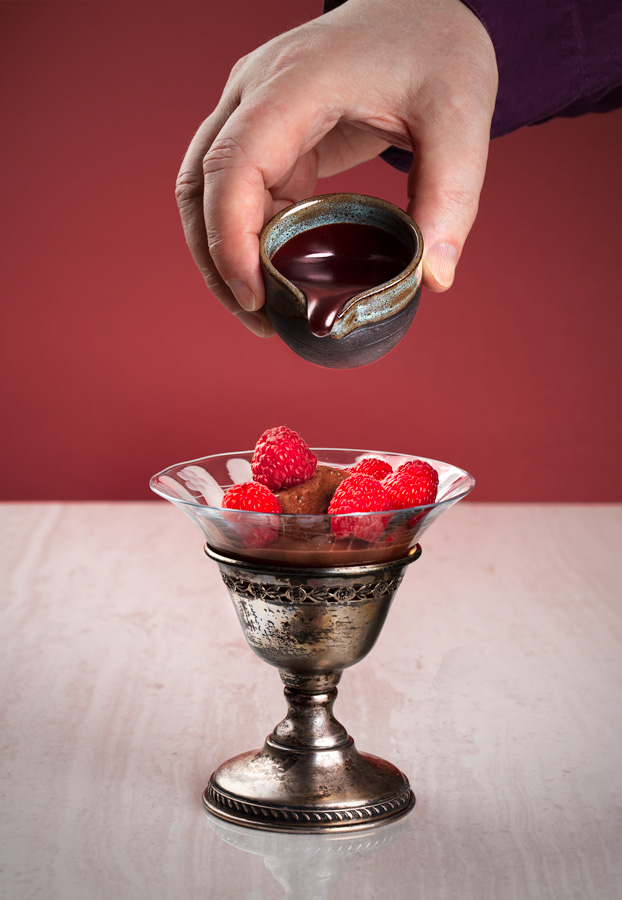 Chocolate sauce and chocolate gelato with raspberries