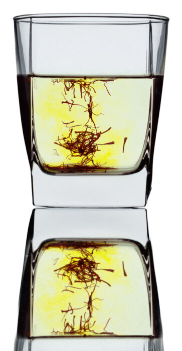 saffron infusing into water in a glass