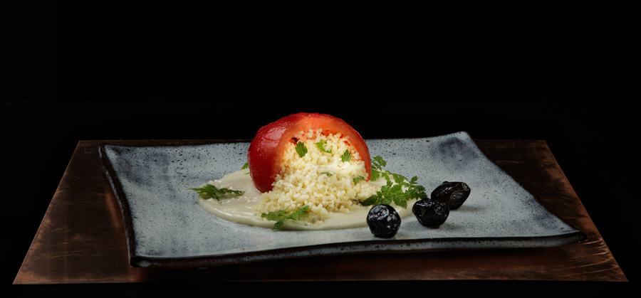 early tomato stuffed with couscous on a vegan miso mayo